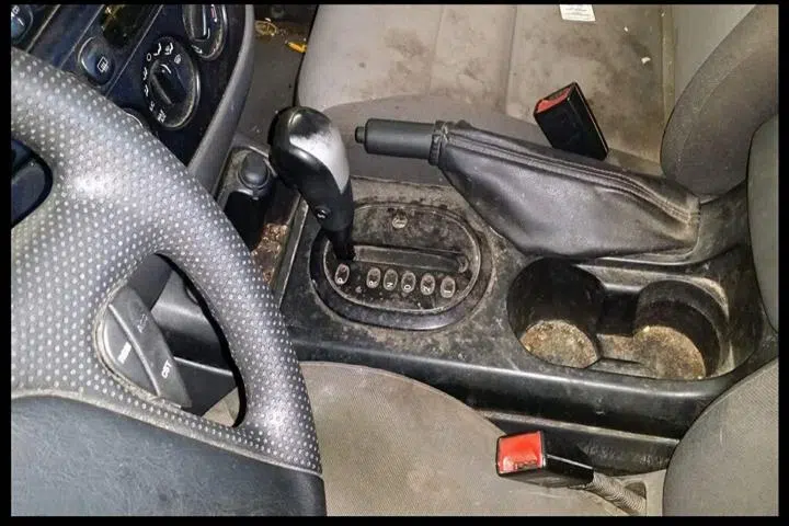 Dirty car interior console with grimy shifter and cup holders — Sharp Image Auto Detail, L.L.C. in Brodhead